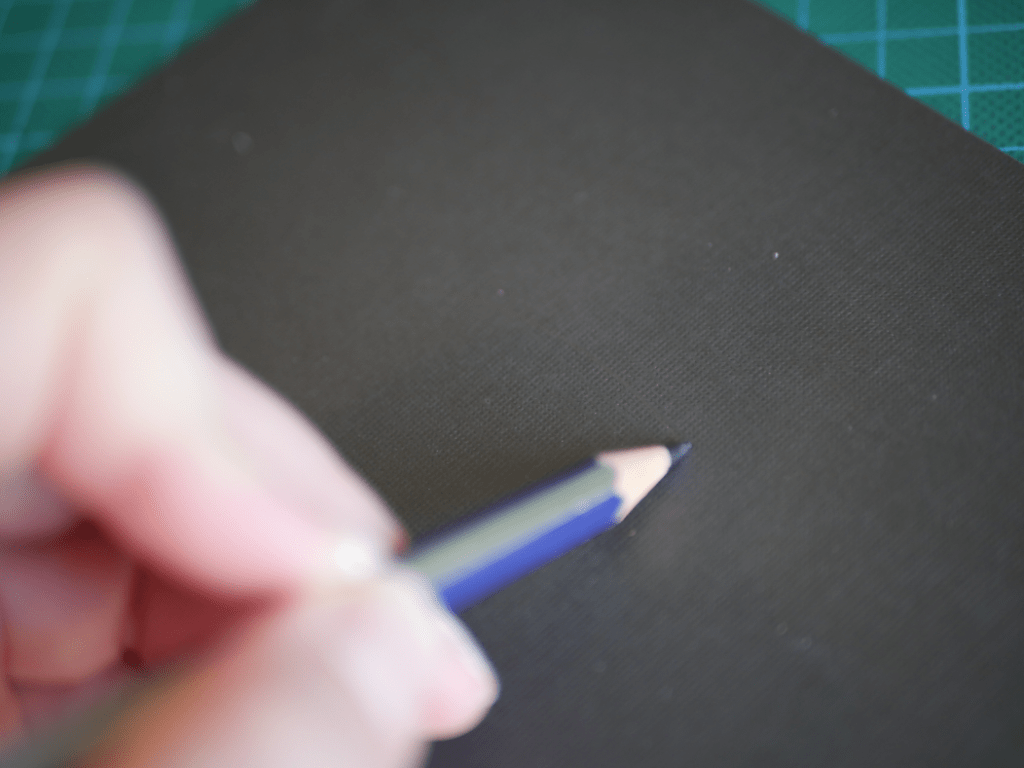 A pencil drawing the outline of a bat wing.